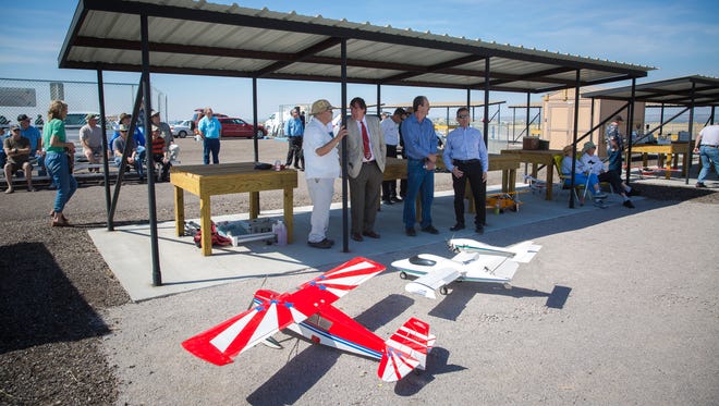 Visitors and city officials, including Las Cruces Mayor Pro Tem Greg Smith, second from left, attend the opening of the new Model Airplane and Archery Facility, April 22, 2016.