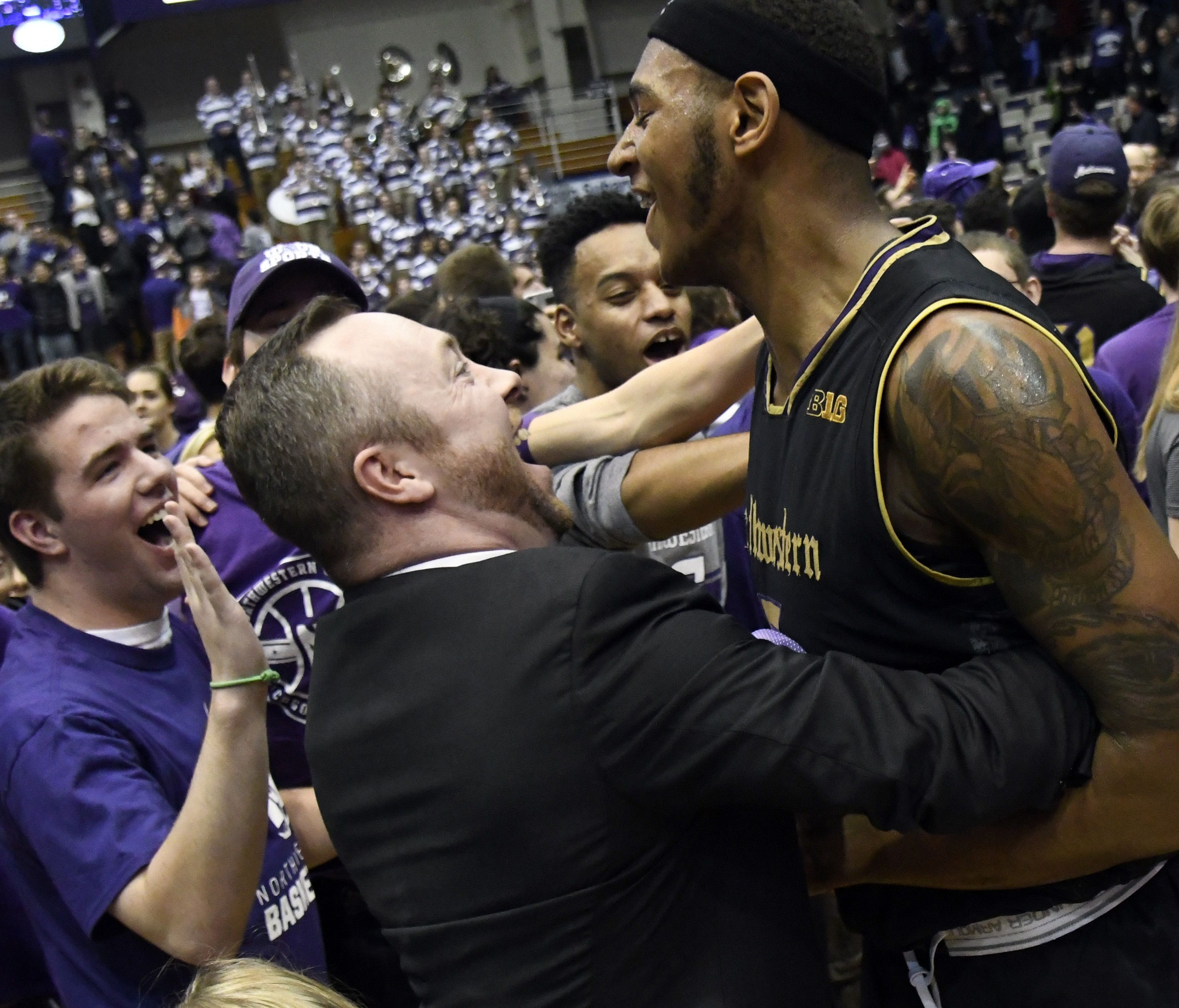 Northwestern center Dererk Pardon celebrates with fans after scoring the game-winning basket against Michigan.