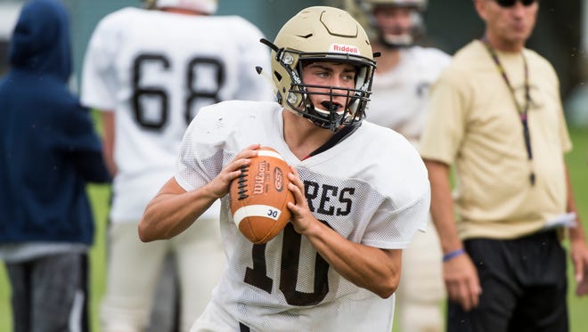 Delone Catholic quarterback Evan Brady drops back to throw during a team practice on Tuesday. Brady, a junior, took over the starting quarterback role this season and has led the Squires to a 2-0 start while notching 5 touchdowns and over 350 passing yards.