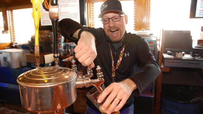 Vince Wright, head brewer at Fin City pours beer at 2016's Shore Craft Beer Fest: Love on Tap. Fin City was one of several brewers that debuted beers at the event. This year's even will be held on Feb. 25, 2017.
