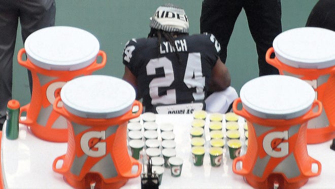 Marshawn Lynch sits during the national anthem during the Raiders game vs. the Patriots in Mexico. Lynch stood for the Mexican anthem.