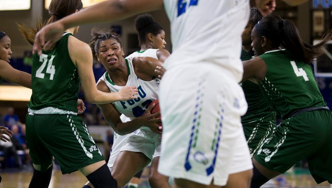 FGCU's Tytionia Adderly, left, is swarmed by Jacksonville defenders after bringing down a rebound in the second half of action during the semifinal game of the Atlantic Sun tournament at Alico Arena Wednesday, March 8, 2017 in Estero. FGCU would win 68-64 advancing to the Atlantic Sun Championship Game. 