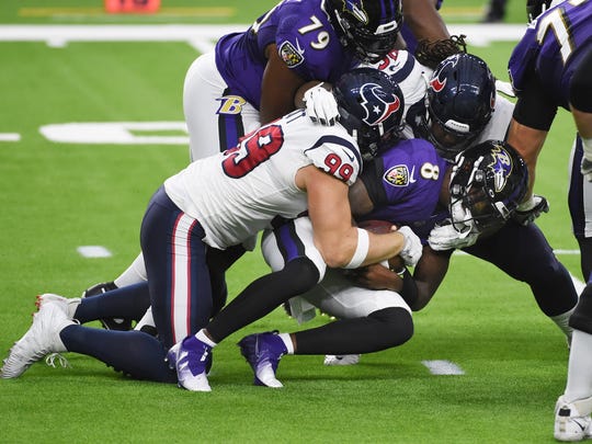 Baltimore Ravens quarterback Lamar Jackson (8) is sacked by Houston Texans defensive end J.J. Watt (99) during the first half of an NFL football game Sunday, Sept. 20, 2020, in Houston. (AP Photo/Eric Christian Smith)