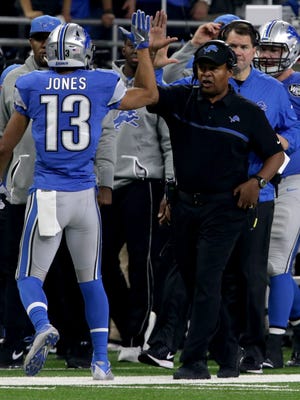 Lions wide receiver TJ Jones gets a high-five on the sideline by coach Jim Caldwell after his first-down catch and run during the first half Sunday at Ford Field.