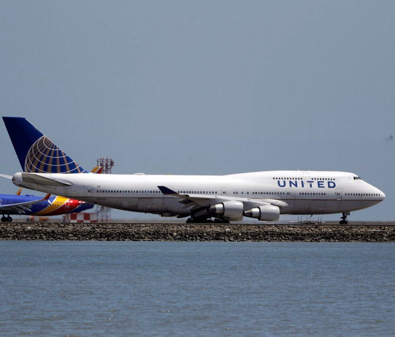 A United Airlines jet sits on a runway July 11, 2017, at San Francisco International Airport.
