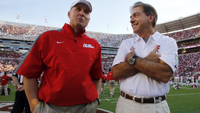 In this Sept. 28, 2013 photo, Alabama coach Nick Saban, right, talks with Mississippi coach Hugh Freeze before an NCAA college football game in Tuscaloosa, Ala. College football turns to the SEC's Western Division on Saturday. It's the first time one division will have three league games featuring six ranked teams in one weekend: No. 3 Alabama at No. 11 Mississippi, No. 6 Texas A&M at No. 12 Mississippi State and No. 15 LSU at No. 5 Auburn.  (AP Photo/Butch Dill, File)
