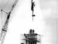 Statue of Mercury is hoisted atop the Lawyers' Co-Op