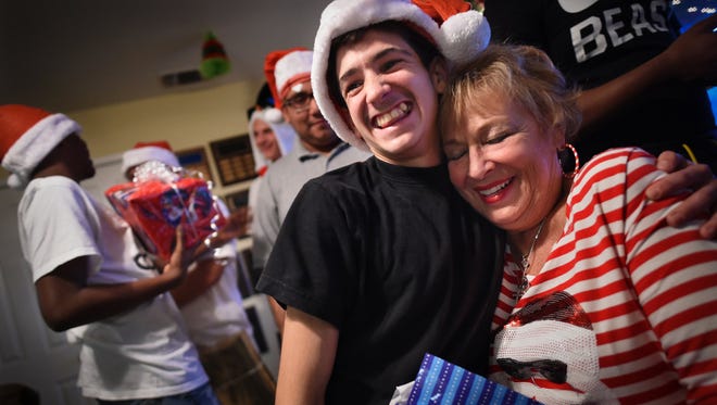 Valley Teen Ranch resident Clay, 18, hugs ranch CEO Connie Clendenan during the ranch Christmas party. Clay said he never really had Christmas as a kid and that this one was the best ever.