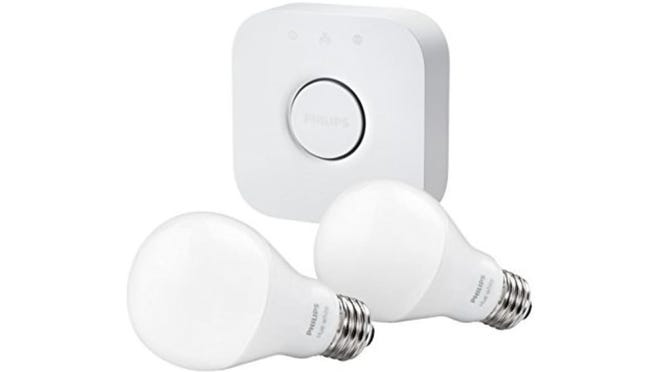 Two Philips Hue lightbulbs with the "Bridge" unit that connects to the router and controls the system