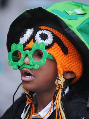 Jayveon Etherly of Two Rivers watches the annual St. Patrick's Day parade.