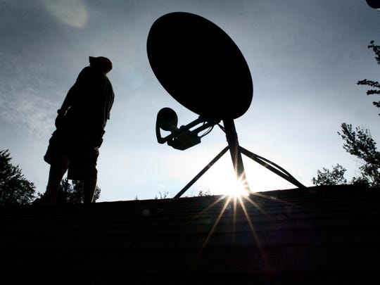 Cuomo vetoes bill to study state-owned internet service Whether in search of broadband internet or television, many residents rely on satellite signals. Here, Jeff Synder of Underhill, Vermont, watches the skies from the roof of his home in 2010.