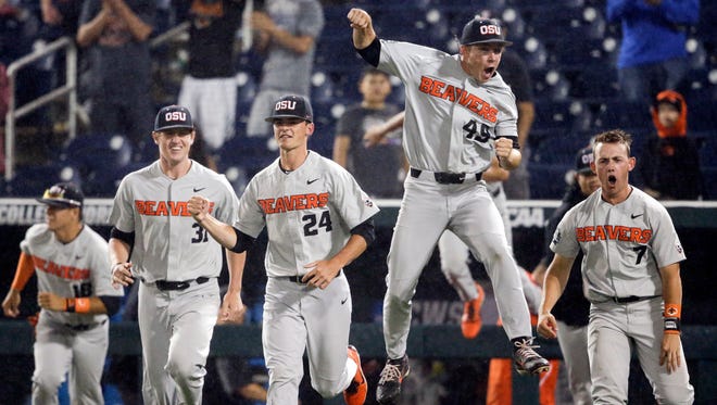 Oregon State players celebrate after the final out against North Carolina in an NCAA College World Series baseball elimination game in Omaha, Neb., Wednesday, June 20, 2018. Oregon State won 11-6.