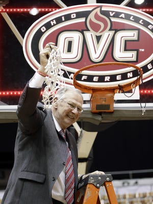 Austin Peay coach Dave Loos cuts down the net after beating UT Martin to win the OVC Tournament on Saturday.