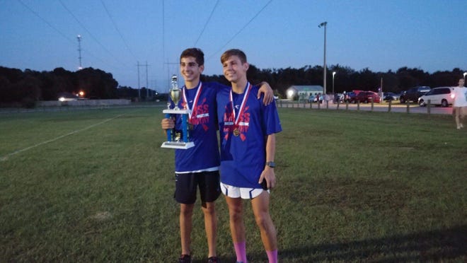 Pace High sophomore Francisco Ramirez, left, with team Aza Boykin, won his fifth individual cross country title this season at the EscaRosa County Championships. Pensacola Christian Academy boys won their first team title in school history.