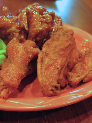 The Angry Owl Southwest Grill & Cantina's Owl Wings are lightly fried and tossed in your choice of a traditional spicy wing sauce or a tangy honey chipotle barbecue sauce. Wing lovers now can get the grill's food on the East Side, too.