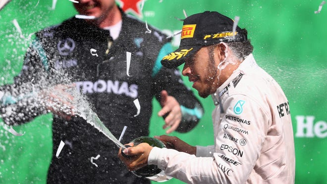 Lewis Hamilton of Great Britain and Mercedes GP celebrates his win on the podium during the Formula One Grand Prix of Mexico at Autodromo Hermanos Rodriguez on October 30, 2016 in Mexico City, Mexico.