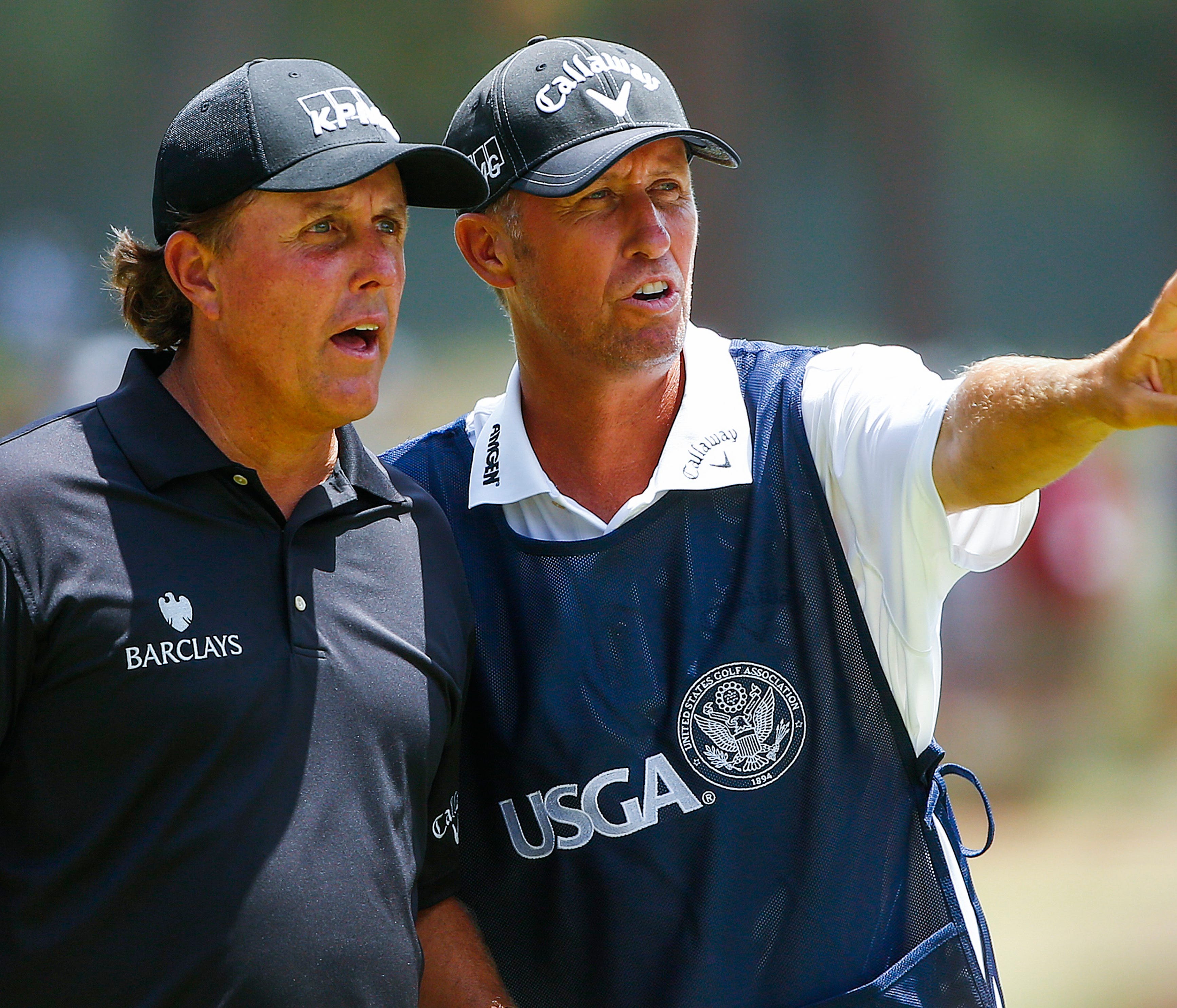 epa06042099 (FILE) - Phil Mickelson of the US (L) and his caddie Jim Mackay (R) talk on the seventh tee during the first round of the 2014 US Open Championship on the Pinehurst No. 2 course at the Pinehurst Resort and Country Club in Pinehurst, North