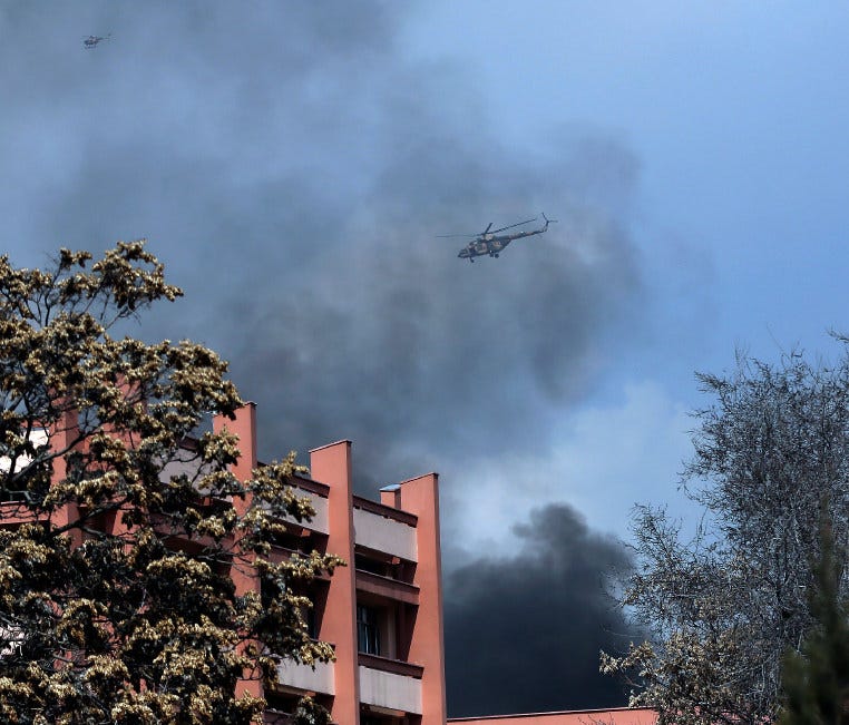 Army helicopters fly over the biggest military hospital in Afghanistan after a clash started between insurgent fighters and army soldiers at the gate of the hospital, in Kabul, on March 8.