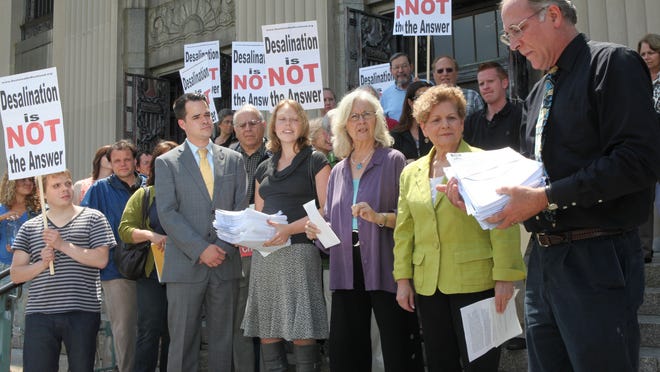 George Potanovic, right, of the Rockland Water Coalition, holds petitions on the steps of the Rockland County Courthouse on June 25, 2012, opposing United Water’s plans to construct a $189 million desalination plant. The Rockland Water Coalition will receive a 2015 Environmental Champion Award from the U.S. Environmental Protection Agency Region 2 for its successful effort to stop the project.