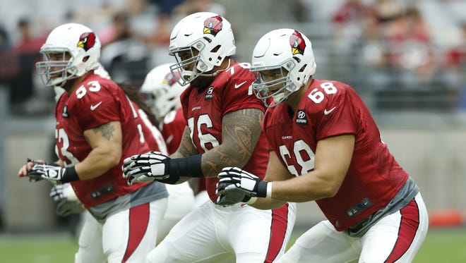 Arizona Cardinals offensive line including center A.Q. Shipley (53), LG Mike Iupati (76) and LT Jared Veldheer (68) perform drills during training camp at University of Phoenix Stadium in Glendale August 10, 2015.