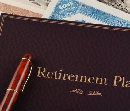 Retirement plan portfolio on top of stock certificates.