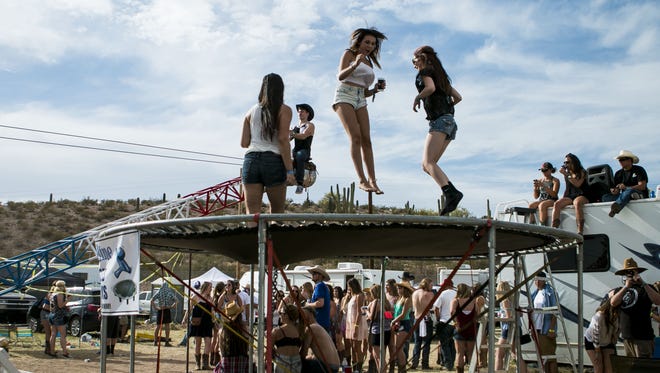 Country Thunder campers jump on a giant trampoline set up between RVs on day four of the Country Thunder Music Festival in Florence, Ariz., Sunday, April 12, 2015.