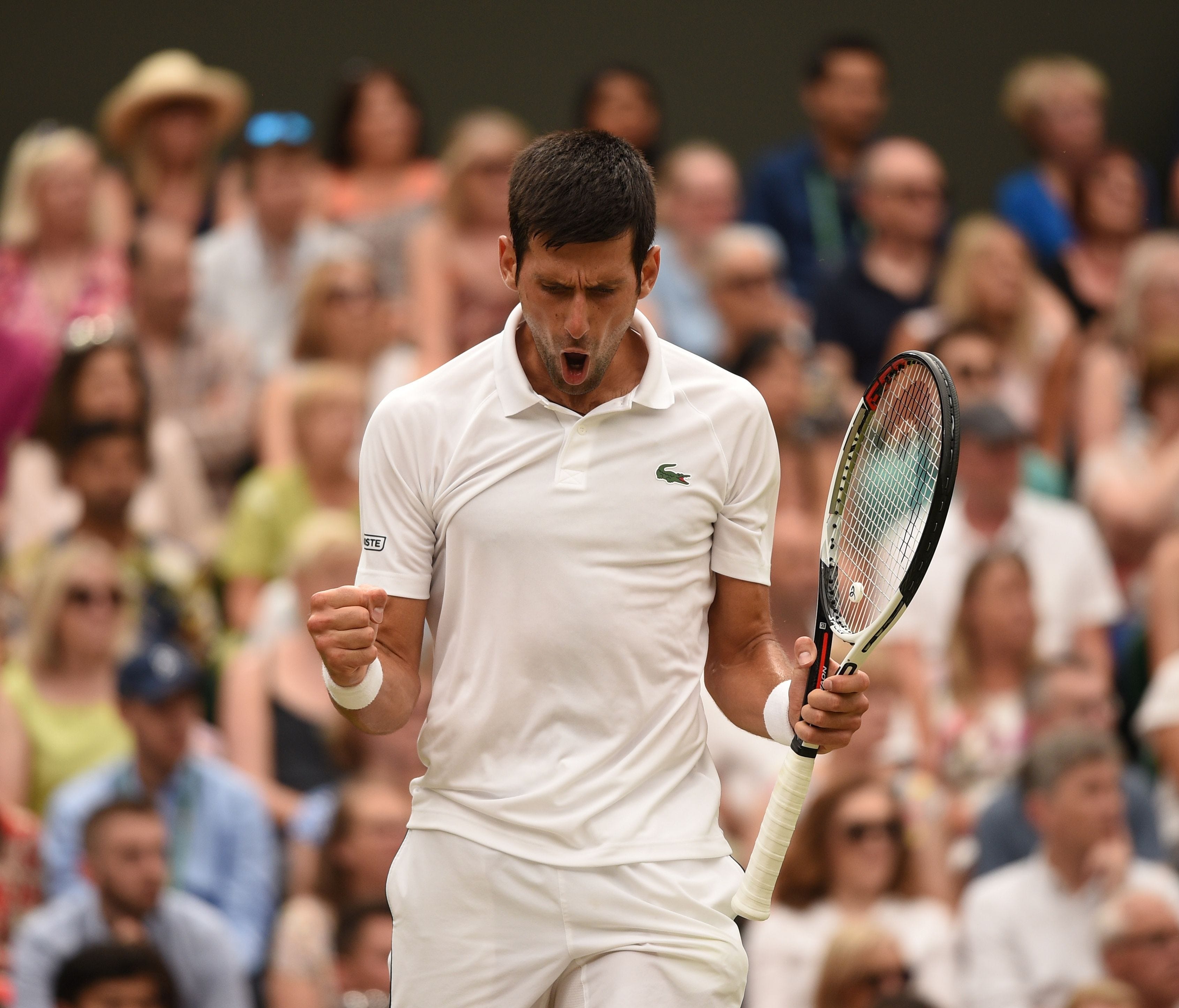 Serbia's Novak Djokovic reacts in the fifth set against Spain's Rafael Nadal during the continuation of their men's singles semifinal match during the 2018 Wimbledon Championships on July 14.