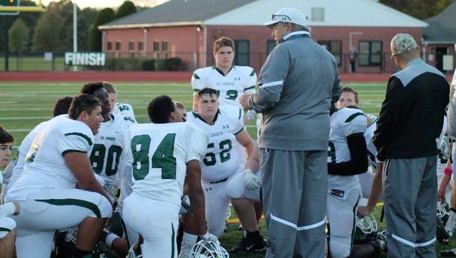 Michael Cleary addresses St. Joseph football players after a game