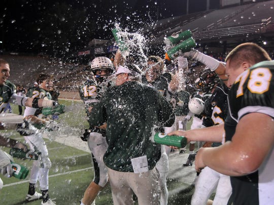 Edgewood head coach Bobby Carr gets doused during the