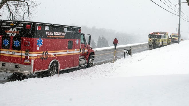 A Penn Township ambulance sits on the side of the road as Pleasant Hill fire trucks and a Pleasant Hill ambulance, along with a medic unit from Hanover Hospital responded to a snowblower accident, Tuesday, March 14, 2017. A man reached into his snowblower and injured his hand, an official said.