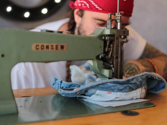 A man embroiders denim at the 2018 Stagecoach music