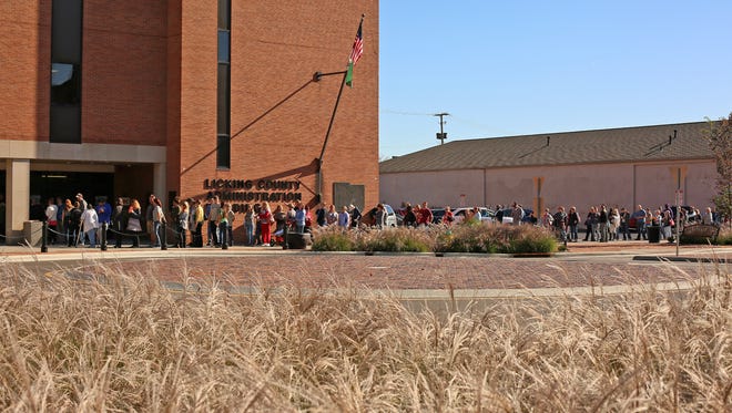 Voters wait in a long line Monday afternoon outside of the Licking County Administration Building on Courthouse Square. 