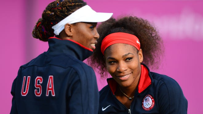 Venus and Serena Williams shown prior to a match in the 2012 Olympics. The sisters have grown from young stars to players who have inspired others to play tennis.