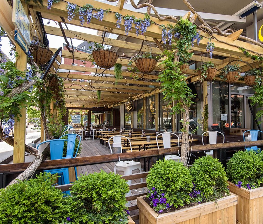 In New York City's The Gansevoort Hotel Meatpacking, The Chester restaurant hosts a wraparound Biergarten with airy seating amidst lush plants.