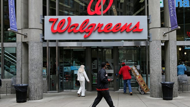 FILE - This June 4, 2014, file photo, shows a Walgreens retail store in Boston. Shares of AmerisourceBergen are soaring before the opening bell, Tuesday, Feb. 13, 2018,  on reports that Walgreens is pursuing a complete takeover of the huge drug distributor. The Wall Street Journal is reporting that Walgreens CEO Stefano Pessina reached out to AmerisourceBergen Corp. with the potential deal. Walgreens already owns about 26 percent of the company. (AP Photo/Charles Krupa, File) ORG XMIT: NY109