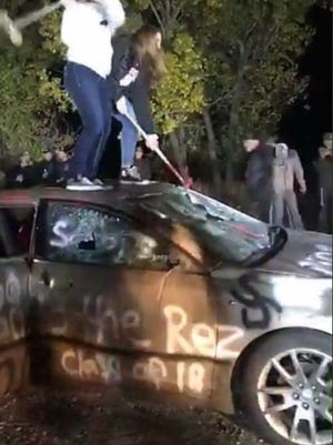 One of the pictures of the car, which is painted with a racist comment.