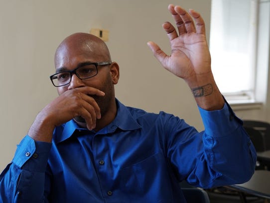 Carmen Garner, 40, shows the bandaid tattoo on his