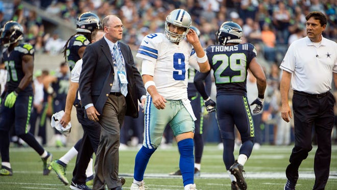 Dallas Cowboys quarterback Tony Romo (9) walks off the field after getting injured during the first quarter during a preseason game against the Seattle Seahawks at CenturyLink Field.