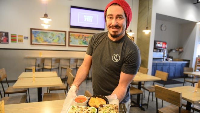 Orion Cameron, general manager at Grandpa Mac, shows off vegan selections, including the Nutty Fireman, a large ridged elbow pasta, with vegan walnut chili, green onion, vegan mozzarella and bread crumbs.
