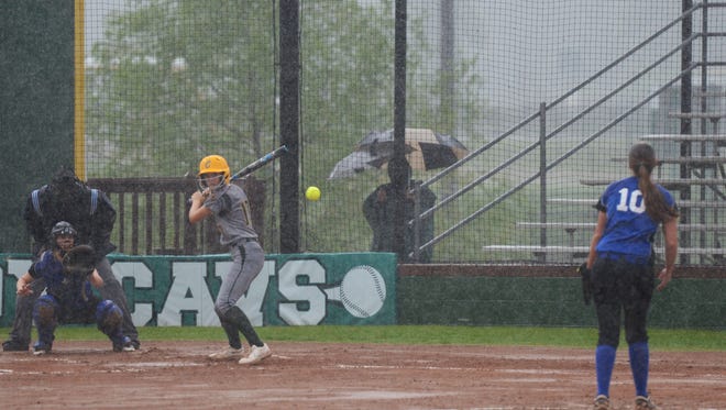 Calvary softball team tries their best to play in the rain at their home field.
