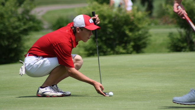 Owen Seay of Big Rapids carefully marks his ball on the green during the Division 3 state golf championship on Friday, June 8, 2018.