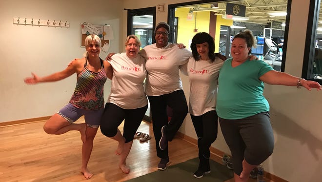 BetterU participants, including Amanda Balint (second from right) are trying Yoga at Gold’s Gym to help strengthen their core and manage stress.