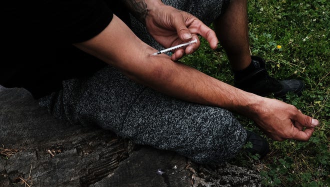 A man shoots heroin in a park in the South Bronx on June 7, 2017 in New York City. Like Staten Island, parts of the Bronx are experiencing an epidemic in drug use, especially heroin and other opioid based drugs. More than 1,370 New Yorkers died from overdoses in 2016, the majority of those deaths involved opioids. The Mott Haven-Hunts Point area of the Bronx borough of New York currently leads the city in heroin overdose deaths. 