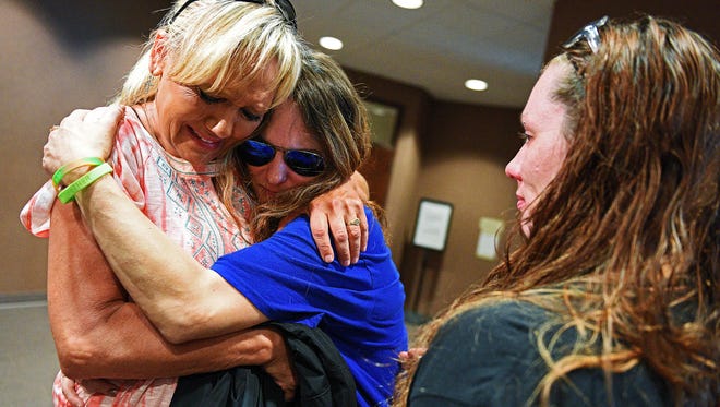 Amiee Strauser, mother of Arick Strauser, who was found beaten in a Sioux Falls driveway in July of 2016, gets a hug from cousin June Huntimer, left, as friend Lacey Wardell, right, stands by Monday, June 5, 2017, at the Minnehaha County Courthouse in Sioux Falls after Wilson Hughes, 17, entered a guilty plea to first-degree manslaughter in the death of her son. 