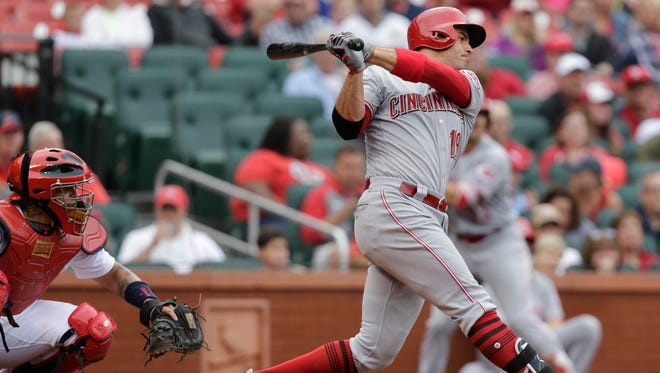 Cincinnati Reds' Joey Votto (19) follows through on his winning RBI-single as St. Louis Cardinals catcher Yadier Molina, left, looks on in the eighth inning of a baseball game, Sunday, April 30, 2017, in St. Louis. (AP Photo/Tom Gannam)