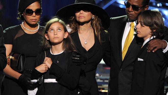 In this July 7, 2009 file photo, the Jackson family, from left, Janet Jackson, Paris Jackson, LaToya Jackson, Jackie Jackson and Prince Michael appear on stage at the memorial service for music legend Michael Jackson, at the Staples Center in Los Angeles. Michael Jackson died on June 25, 2009.