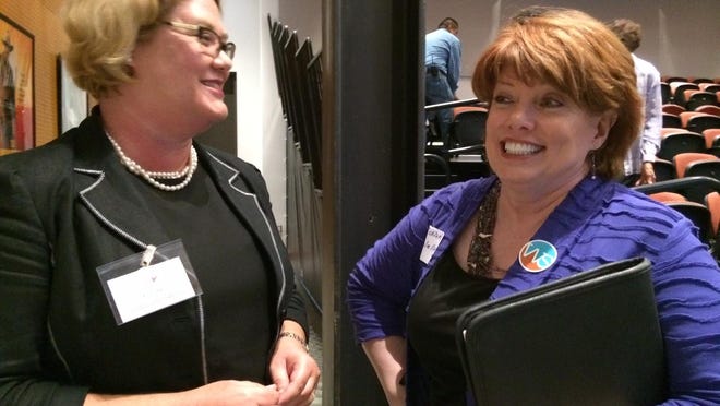 In this 2015 file photo, Kristi Hall, left, owner of Conscious Connections, a Phoenix consulting firm, talks with job hunter Cic Cicolello, 50, of Tempe, at the BestCompaniesAZ Womens Career Event in Scottsdale.