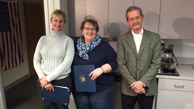 Laurie Aren of the Plymouth Salvation Army (center), with Andrea Hug, president of the Plymouth-Canton Parent School Council and former school board Trustee John Barrett, was honored last year by the Plymouth-Canton Board of Education.