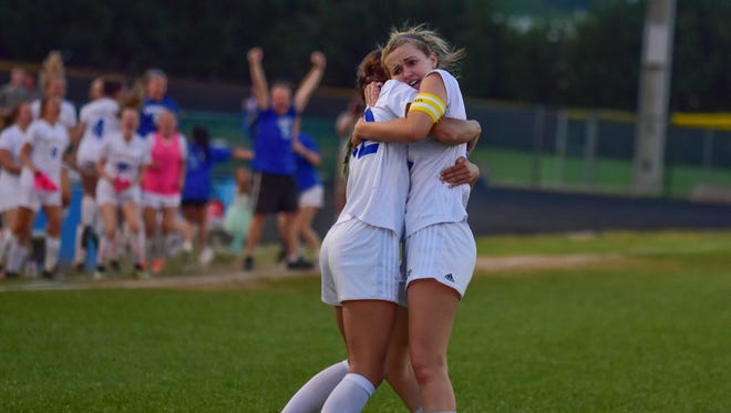 Eastside's Ansley Robinson, right gets a hug from teammate Olivia Kelly after Robinson scored the tying goal in the Eagles' victory against South Aiken in Monday night's Class AAAA girls soccer Upper State championship match at Eastside.