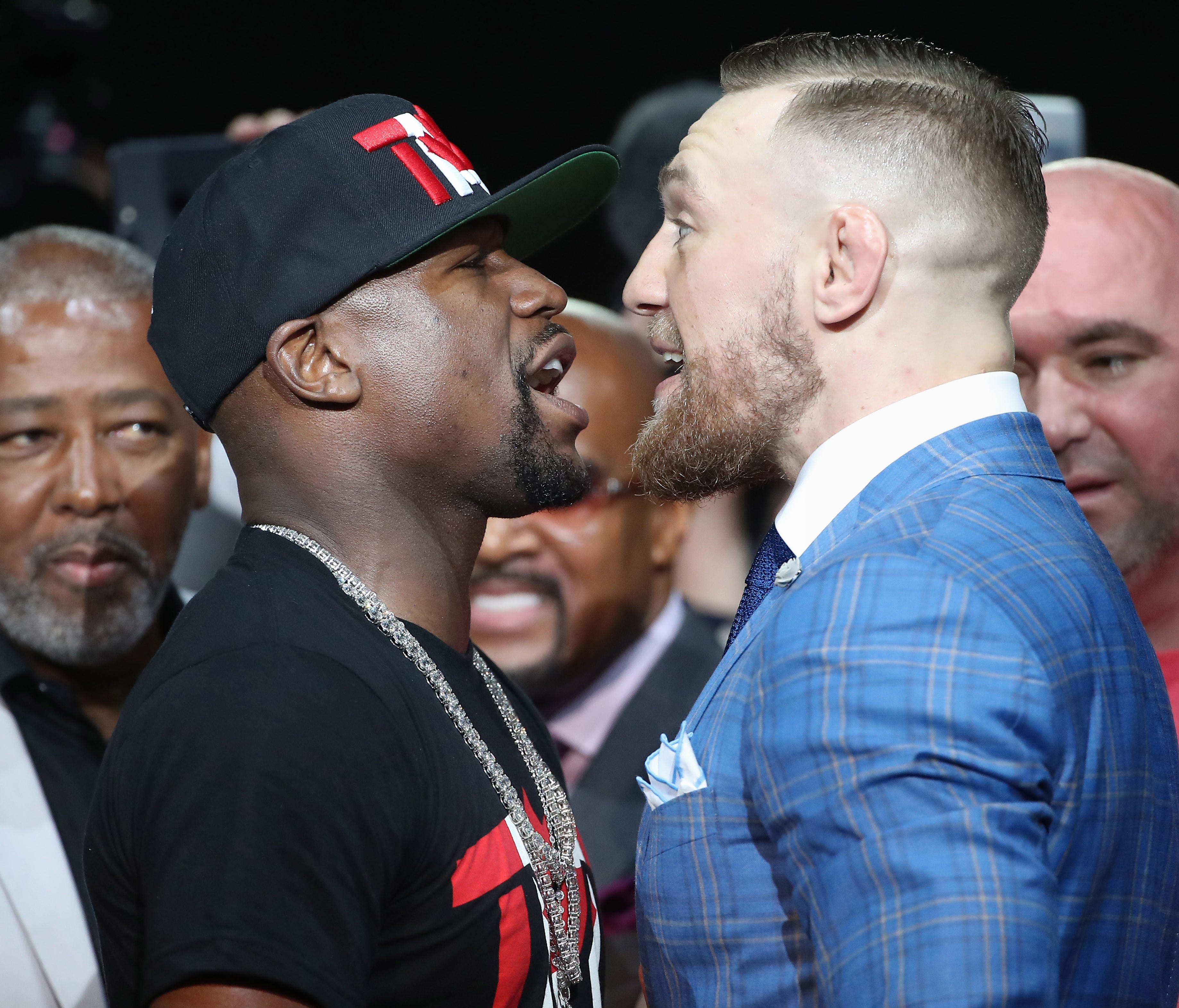 Floyd Mayweather and Conor McGregor stare each other down during a world tour press conference.